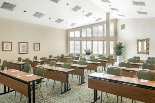a classroom with tables and chairs in a room with windows at DoubleTree by Hilton Campbell - Pruneyard Plaza in Campbell