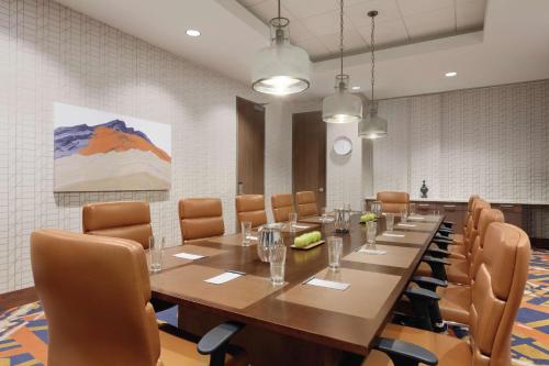 a large conference room with a long table and chairs at Embassy Suites By Hilton South Jordan Salt Lake City in South Jordan