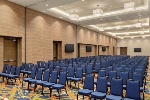an empty room with blue chairs in a hall at Embassy Suites By Hilton South Jordan Salt Lake City in South Jordan