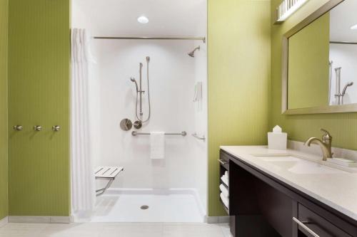 a bathroom with a shower and a sink at Home2 Suites by Hilton Salt Lake City-Murray, UT in Murray