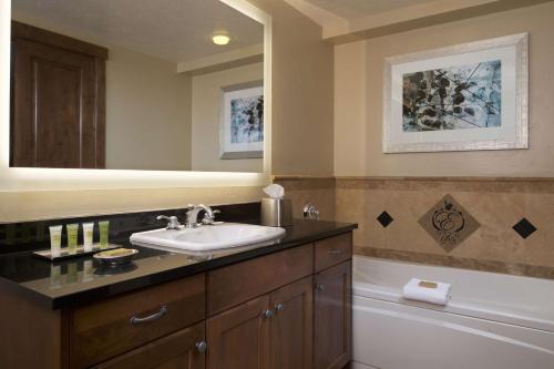 a bathroom with a sink and a bath tub at Hilton Grand Vacations Club Sunrise Lodge Park City in Park City