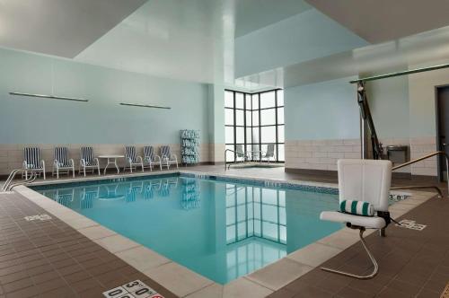 a large swimming pool with a chair at Embassy Suites by Hilton Salt Lake West Valley City in West Valley City