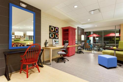 a waiting room with a red chair and a mirror at Home2 Suites by Hilton Lehi/Thanksgiving Point in Lehi