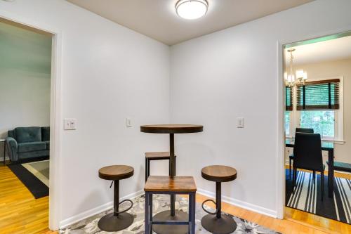 a living room with two stools and a table at Charleston Vacation Home 6 Mi to Downtown and Beach! in Charleston