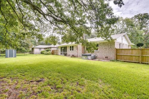 a yard with a house and a fence at Charleston Vacation Home 6 Mi to Downtown and Beach! in Charleston
