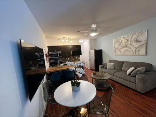 a living room with a couch and a table at The Pearl Beachside Apartments on Hollywood Beach in Hollywood