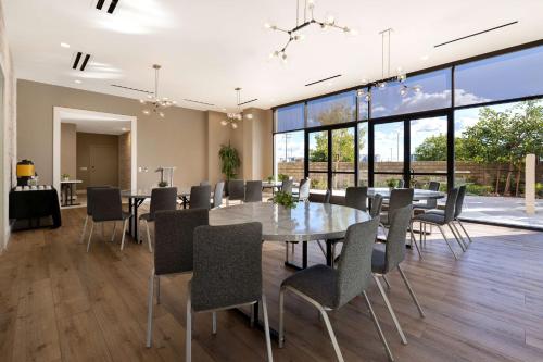 a dining room with a table and chairs at Hilton Garden Inn Anaheim Resort in Anaheim