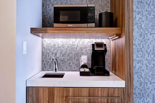 a kitchen with a sink and a microwave at Hilton Garden Inn Anaheim Resort in Anaheim