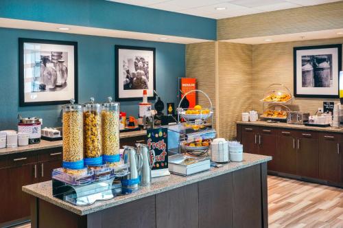 a restaurant with a counter with food on it at Hampton Inn & Suites by Hilton Mission Viejo Laguna San Juan Capistrano in Mission Viejo