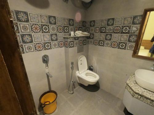 a small bathroom with a toilet and a sink at OLIVIA HOME STAY in Dehradun
