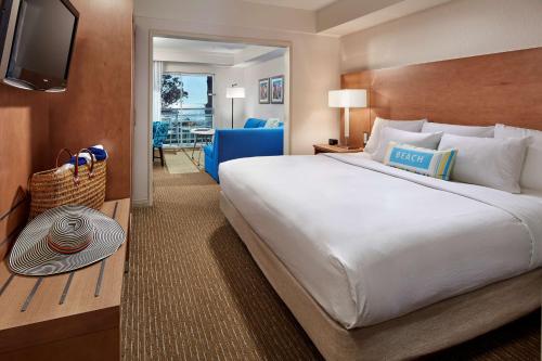 a hotel room with a large bed and a television at DoubleTree Suites by Hilton Doheny Beach in Dana Point