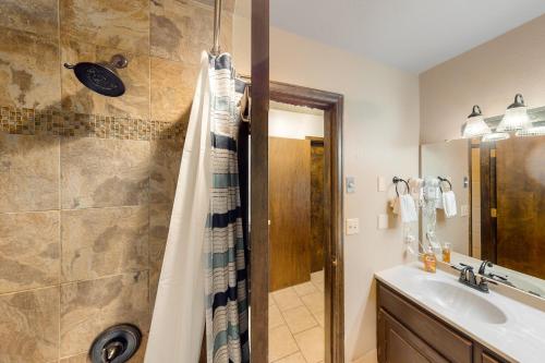 a bathroom with a shower and a sink at Silver Lodge A in Granby