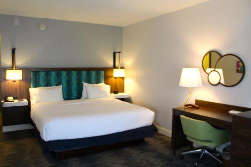 a hotel room with a large bed and a desk at Hampton Inn & Suites Sarasota / Bradenton - Airport in Sarasota