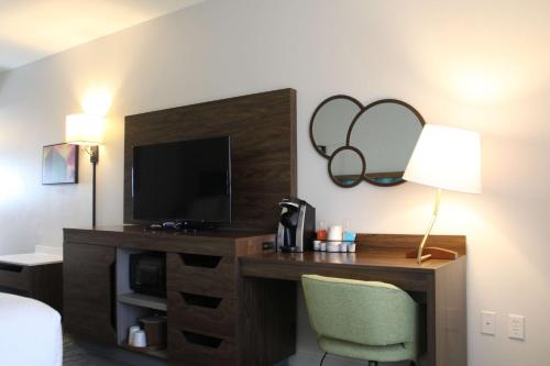 a hotel room with a desk with a television at Hampton Inn & Suites Sarasota / Bradenton - Airport in Sarasota