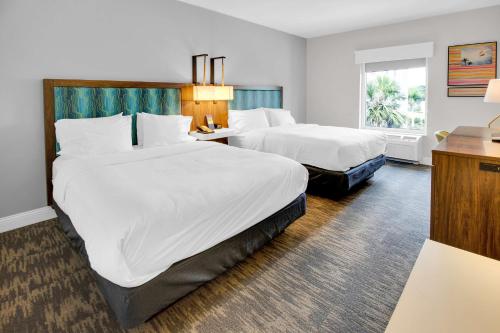 a hotel room with two beds and a window at Hampton Inn & Suites Sarasota / Bradenton - Airport in Sarasota