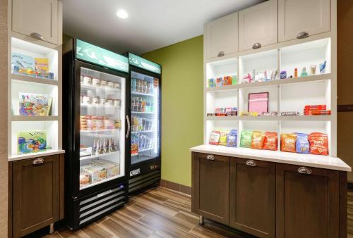 a kitchen with two refrigerators with food in them at Homewood Suites by Hilton Saint Louis-Chesterfield in Chesterfield