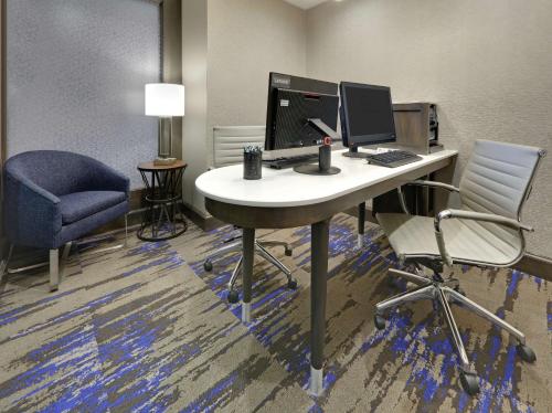 an office with a desk with a computer and two chairs at Homewood Suites by Hilton Saint Louis-Chesterfield in Chesterfield