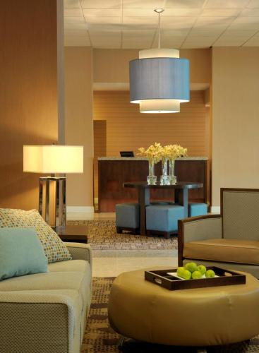 a living room with a couch and a table at DoubleTree by Hilton St. Louis at Westport in Maryland Heights