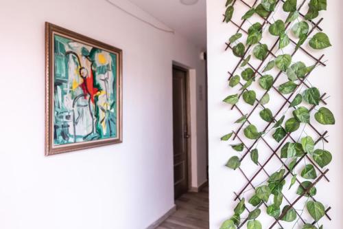 a ivy covered wall in a room with a painting at Hotel Las Rosas de Punta Cana in Punta Cana