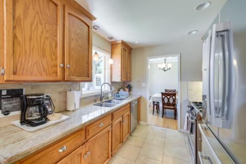 a kitchen with wooden cabinets and a stainless steel refrigerator at Campbell Vacation Rental about 8 Mi to San Jose! in Campbell