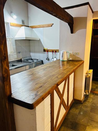 a large kitchen with a wooden counter top at Aldea Andina Hotel&Spa in San Carlos de Bariloche