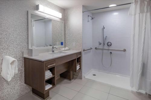 a bathroom with a sink and a shower and a tub at Home2 Suites By Hilton Wayne, NJ in Wayne