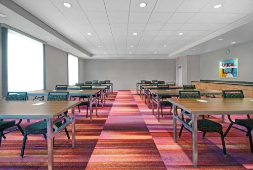 a classroom with tables and chairs in a room at Home2 Suites By Hilton Utica, Ny in Utica