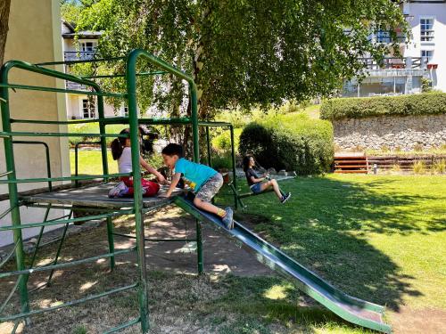 a group of children playing on a playground at Aldea Andina Hotel&Spa in San Carlos de Bariloche