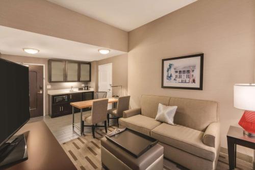 a living room with a couch and a table at Embassy Suites by Hilton Tuscaloosa Alabama Downtown in Tuscaloosa