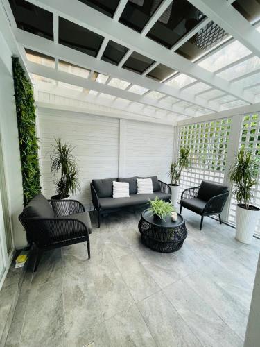 a patio with a couch and chairs and plants at Aici te simți ca acasa 2 in Iaşi