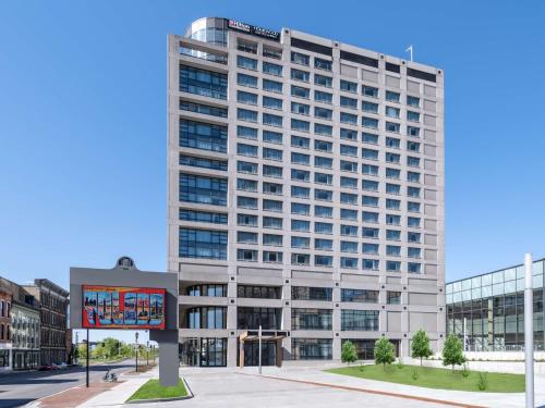 a tall building with a sign in front of it at Hilton Garden Inn Toledo Downtown in Toledo