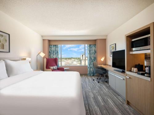 a hotel room with a bed and a television at Hilton Garden Inn Toledo Downtown in Toledo