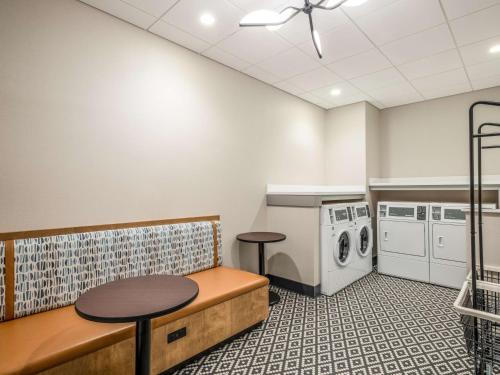 a laundry room with a bench and a washer and dryer at Hilton Garden Inn Toledo Downtown in Toledo