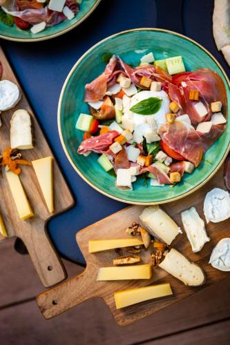 a plate of food with a salad and cheese on a table at Oceania Paris Porte De Versailles in Paris