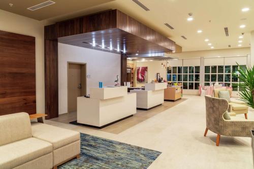 a store lobby with a couch and chairs and tables at Hilton Garden Inn Tampa - Wesley Chapel in Wesley Chapel