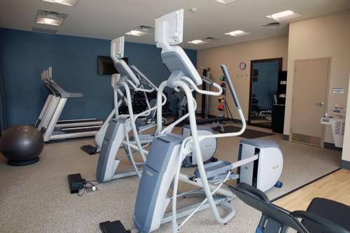 a gym with several tread machines in a room at Hilton Garden Inn Tampa - Wesley Chapel in Wesley Chapel
