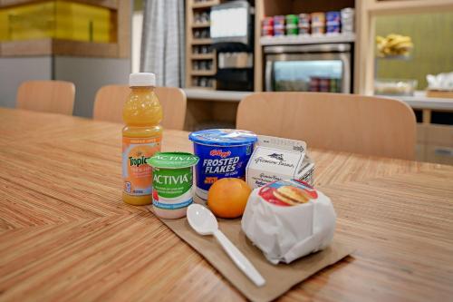 a table with a bottle of orange juice and other groceries at Home2 Suites By Hilton Temple in Temple