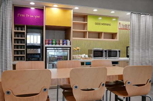 a kitchen with a large wooden table and chairs at Home2 Suites By Hilton Temple in Temple