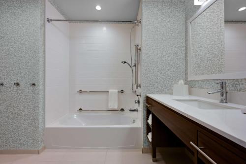 a bathroom with a tub and a sink at Home2 Suites By Hilton Temple in Temple