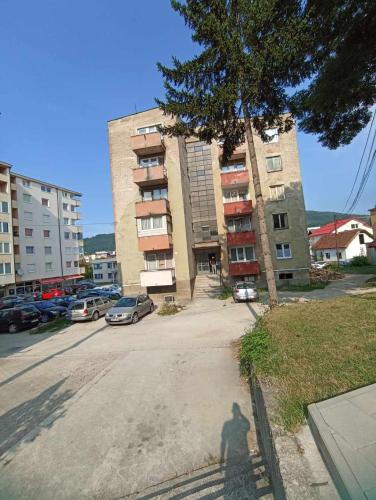 a shadow of a man standing in front of a building at Apartments Emir in Kiseljak