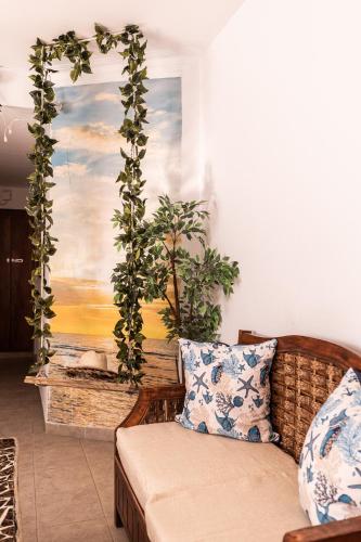 a living room with a couch and a painting on the wall at Hotel Las Rosas de Punta Cana in Punta Cana