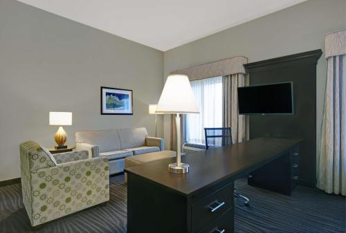 a hotel room with a desk and a living room at Hampton Inn and Suites Robbinsville in Robbinsville
