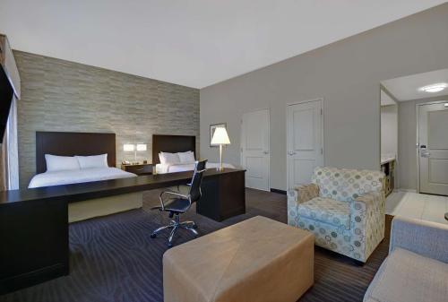 a hotel room with a bed and a desk and a chair at Hampton Inn and Suites Robbinsville in Robbinsville