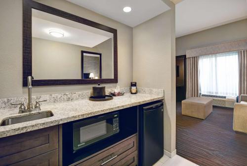 a bathroom with a sink and a mirror at Hampton Inn and Suites Robbinsville in Robbinsville