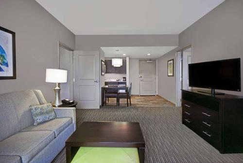 a living room with a couch and a flat screen tv at Homewood Suites by Hilton Hamilton, NJ in Hamilton