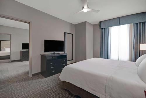 a hotel room with a bed and a television at Homewood Suites by Hilton Hamilton, NJ in Hamilton