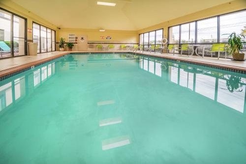 a large swimming pool with blue water in a building at Hampton Inn Tulsa/Broken Arrow in Broken Arrow