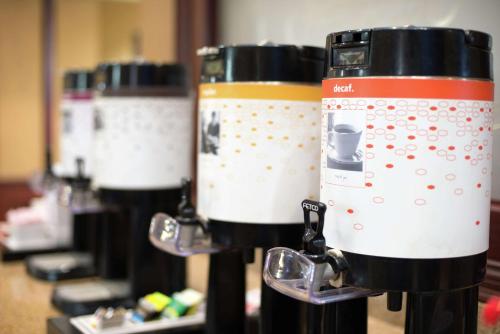 three coffee machines are lined up in a row at Hampton Inn Tulsa/Broken Arrow in Broken Arrow