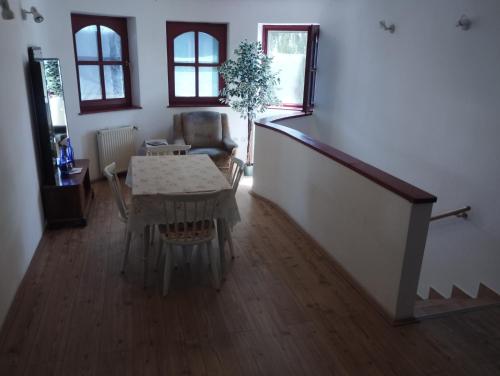 a living room with a table and a chair at Liget Szálláshely in Berettyóújfalu