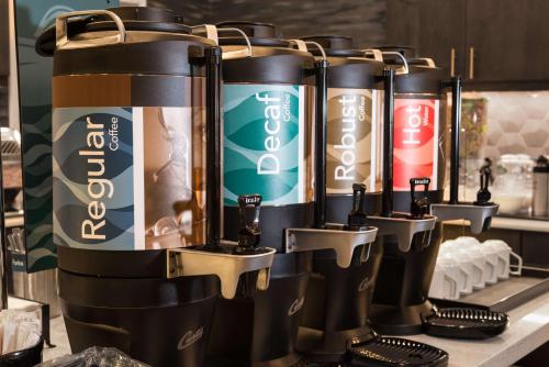 a row of water bottles lined up on a counter at Homewood Suites By Hilton Tulsa Catoosa in Catoosa
